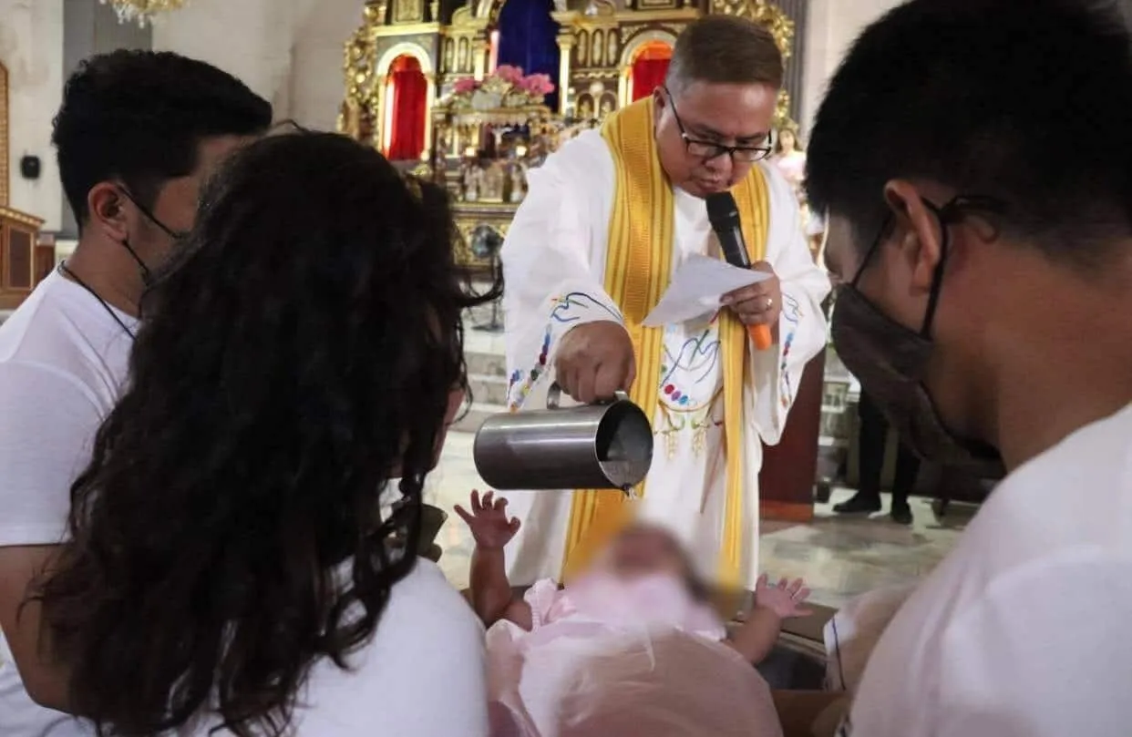 Army officers, men stand as godparents in christening of former rebels' daughter
